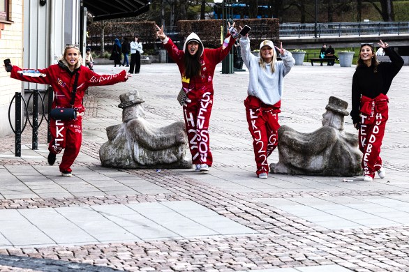 Four high school girls running towards the camera